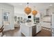 Bright, open kitchen with white cabinetry, stainless steel appliances, and a large island at 2545 Hatch Dr, Johns Island, SC 29455