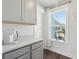 Modern kitchen featuring gray cabinets, quartz countertops, and stainless-steel appliances at 2545 Hatch Dr, Johns Island, SC 29455