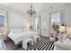 Elegant main bedroom with a chandelier, dark wood floors, and a large comfy bed at 2545 Hatch Dr, Johns Island, SC 29455
