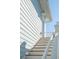 Exterior staircase with painted white railings and wooden steps leading to an upper level at 2545 Hatch Dr, Johns Island, SC 29455