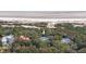 Aerial view showcases a beach house nestled amongst trees with beach access in the background at 263 Pelican Flight Dr, 15.4% Share, Dewees Island, SC 29451