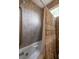 Bathroom with tub shower combo featuring a tan patterned shower curtain and neutral-toned tile surround at 263 Pelican Flight Dr, 15.4% Share, Dewees Island, SC 29451