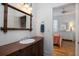 Bathroom vanity featuring a bamboo framed mirror and view into bedroom with bed and dresser at 263 Pelican Flight Dr, 15.4% Share, Dewees Island, SC 29451