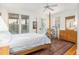 Bright bedroom with a four-poster bed, windows and a dresser with mirror at 263 Pelican Flight Dr, 15.4% Share, Dewees Island, SC 29451