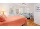 Bedroom with two beds, white walls, wood flooring, ceiling fan, and bright natural light at 263 Pelican Flight Dr, 15.4% Share, Dewees Island, SC 29451