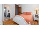 Bedroom with wood floors, white walls, access to bathroom, and nightstand with lamp at 263 Pelican Flight Dr, 15.4% Share, Dewees Island, SC 29451