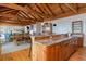 Island kitchen with wood cabinets, granite countertops, stainless appliances, and eat-in area at 263 Pelican Flight Dr, 15.4% Share, Dewees Island, SC 29451