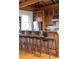 Close-up of kitchen bar with countertop seating, wood cabinets, and stainless steel appliances at 263 Pelican Flight Dr, 15.4% Share, Dewees Island, SC 29451