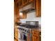 Close-up of a kitchen stove with stainless steel appliances and wood cabinets at 263 Pelican Flight Dr, 15.4% Share, Dewees Island, SC 29451