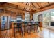 Kitchen with wood cabinets, stainless steel appliances, hardwood floors and a vaulted beamed ceiling at 263 Pelican Flight Dr, 15.4% Share, Dewees Island, SC 29451