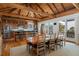Open-concept kitchen and dining area with wood floors, beamed ceilings, and counter seating at 263 Pelican Flight Dr, 15.4% Share, Dewees Island, SC 29451