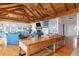 Spacious living room featuring a wood-beamed ceiling, fireplace, and comfortable seating area at 263 Pelican Flight Dr, 15.4% Share, Dewees Island, SC 29451