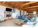 Cozy living room offering a fireplace, beamed ceiling, plush sofas, and built in shelving at 263 Pelican Flight Dr, 15.4% Share, Dewees Island, SC 29451