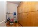 Interior storage area with tall, wall-mounted wood cabinetry, and wood flooring at 263 Pelican Flight Dr, 15.4% Share, Dewees Island, SC 29451