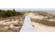 Wooden walkway leading towards sandy dunes and ocean view at 263 Pelican Flight Dr, 15.4% Share, Dewees Island, SC 29451