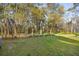 Backyard featuring mature trees with flowering branches, green grass, and a garden swing at 265 Grand Oaks Drive Dr, Ladson, SC 29456
