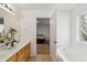 Bathroom featuring double sinks, soaking tub with a window view and an adjacent bedroom at 265 Grand Oaks Drive Dr, Ladson, SC 29456