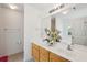 Bright bathroom featuring double sinks, wood cabinets, and a large mirror at 265 Grand Oaks Drive Dr, Ladson, SC 29456
