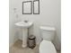 Simple half bath with pedestal sink, standard toilet, and neutral tile flooring at 265 Grand Oaks Drive Dr, Ladson, SC 29456