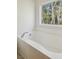 Relaxing soaking tub with tile surround and a bright window view at 265 Grand Oaks Drive Dr, Ladson, SC 29456