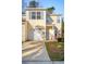 Charming two-story townhouse with a white garage door, sunny facade, and well-kept front yard at 265 Grand Oaks Drive Dr, Ladson, SC 29456