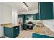Well-equipped kitchen featuring stainless steel appliances, granite countertops, and emerald green cabinets at 265 Grand Oaks Drive Dr, Ladson, SC 29456