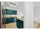 Stylish kitchen with stainless steel appliances, granite countertops, and emerald green cabinetry at 265 Grand Oaks Drive Dr, Ladson, SC 29456