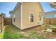 Charming yellow home with small backyard, wood fence, and manicured flower beds at 2739 Calico Bass Ln, Johns Island, SC 29455
