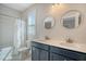 Well-lit bathroom features a double vanity, framed mirrors, and a shower with a curtain at 2739 Calico Bass Ln, Johns Island, SC 29455