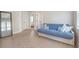 Comfortable bedroom with a blue futon, wood floors, and natural light, perfect for relaxation and rest at 2739 Calico Bass Ln, Johns Island, SC 29455