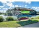 Wooden rack with colorful canoes and kayaks alongside a scenic lake with clear skies at 2739 Calico Bass Ln, Johns Island, SC 29455