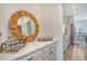 Stylish counter area with decorative mirror, black wire basket, and easy access to the adjacent kitchen at 2739 Calico Bass Ln, Johns Island, SC 29455