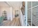 Bright entryway features wood floors, staircase, and views into the living room creating an inviting space at 2739 Calico Bass Ln, Johns Island, SC 29455