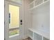 Bright entryway with built-in bench and storage, complemented by an exterior view through a glass door at 2739 Calico Bass Ln, Johns Island, SC 29455