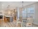 Bright kitchen and dining area featuring stainless steel appliances, island with bar stools, and pendant lighting at 2739 Calico Bass Ln, Johns Island, SC 29455