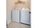 Efficient laundry room with modern washer, dryer, and storage shelf at 2739 Calico Bass Ln, Johns Island, SC 29455
