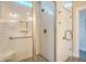 Tiled shower with a glass door, built-in niche, and convenient grab bar at 2739 Calico Bass Ln, Johns Island, SC 29455