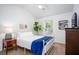 Well-lit bedroom features ceiling fan, white metal bedframe, and stylish dark wood dresser at 275 Kelsey Blvd, Charleston, SC 29492
