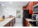 Well-lit kitchen with stainless steel appliances and cherry wood cabinets at 275 Kelsey Blvd, Charleston, SC 29492