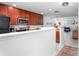 A well-lit kitchen featuring ample counter space, a microwave, and a refrigerator, seamlessly connecting to the living area at 275 Kelsey Blvd, Charleston, SC 29492