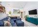 Bright, open living room with vaulted ceilings, a blue sectional, and a large window overlooking the yard at 275 Kelsey Blvd, Charleston, SC 29492