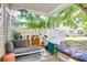 Inviting covered patio with comfortable seating and a view of the green backyard at 275 Kelsey Blvd, Charleston, SC 29492