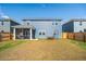 Expansive backyard featuring a screened-in porch and a patio seating area at 284 Shadybrook Dr, Summerville, SC 29486