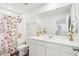 Bright bathroom showcasing a vanity with a floral shower curtain, offering comfort with classic touches at 284 Shadybrook Dr, Summerville, SC 29486