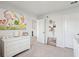 Bright room features a white dresser, books, wall decor, and two doors, maximizing space and style at 284 Shadybrook Dr, Summerville, SC 29486