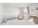 Charming Bedroom with a white crib, cozy armchair, floral wall decals, and a window with pink curtains at 284 Shadybrook Dr, Summerville, SC 29486