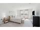 Serene bedroom with large windows, neutral tones, and plush bedding offers a tranquil retreat at 284 Shadybrook Dr, Summerville, SC 29486
