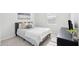 Comfortable bedroom boasts soft carpet, a plush bed, natural light, and neutral decor at 284 Shadybrook Dr, Summerville, SC 29486