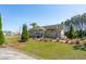 Beautiful community clubhouse surrounded by well-manicured landscaping and a lush green lawn at 284 Shadybrook Dr, Summerville, SC 29486