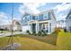 Traditional two-story home with attached garage, landscaped yard, and covered front porch at 284 Shadybrook Dr, Summerville, SC 29486